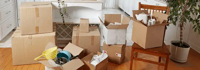 Packed moving boxes and household items in a kitchen before move-out or move-in cleaning, Charleston, SC.